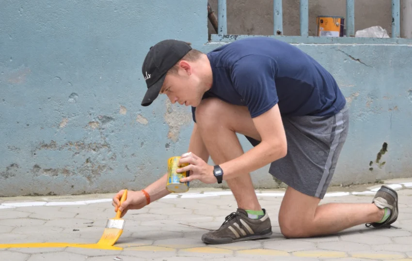 Volunteer doing painting as a part of construction volunteering work in Nepal