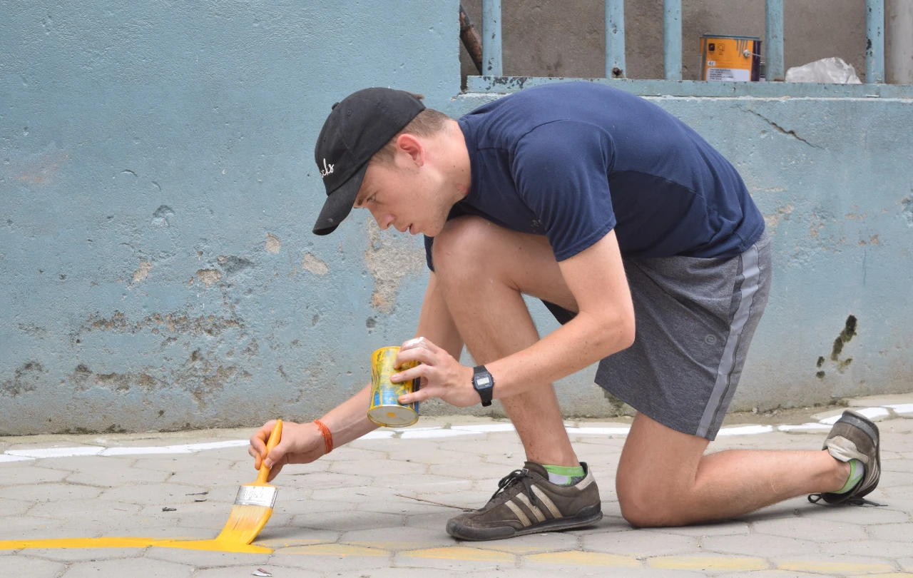 Volunteer doing painting as a part of construction volunteering work in Nepal